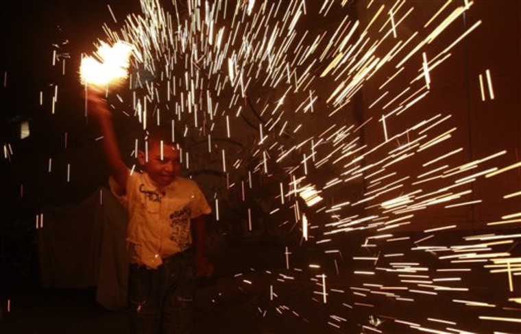 A Palestinian child plays with fireworks on the first day of Ramadan at Shati refugee camp in Gaza City, Wednesday. During the Muslim holy month of Ramadan, observant Muslims abstain from eating, drinking and smoking from sunrise to sunset.